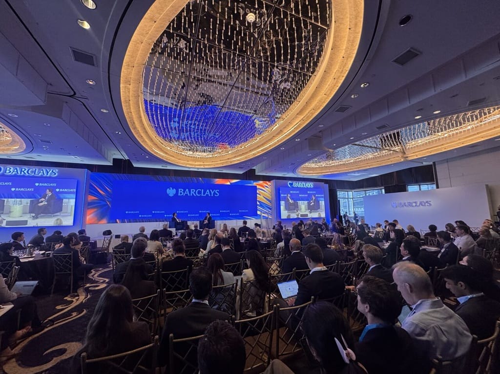 Audience seated under chandeliers at the Barclays NextGen Energy Conference 2026 in New York, with Barclays branding on stage and side screens during a panel session