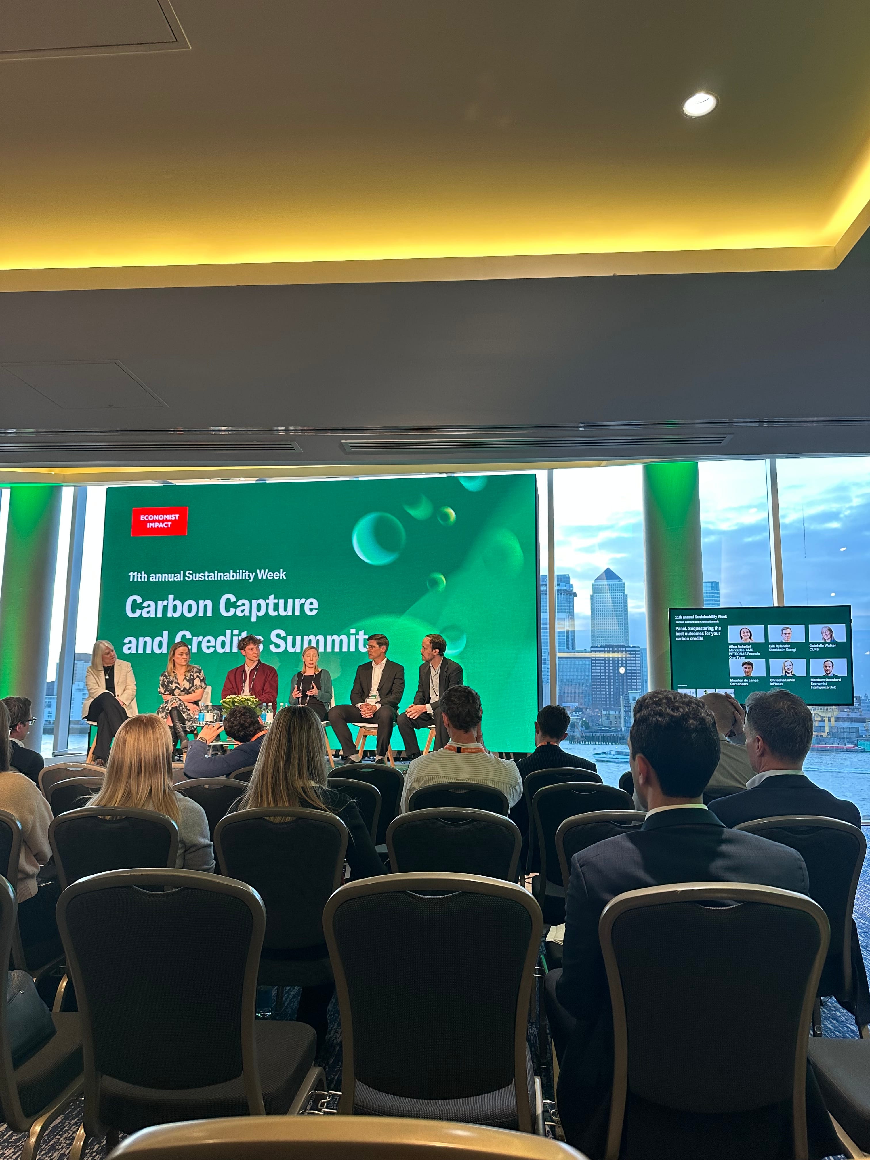 Carbon Capture and Credits Summit panel at the Economist Impact Sustainability Week, with panellists discussing on stage in front of an audience