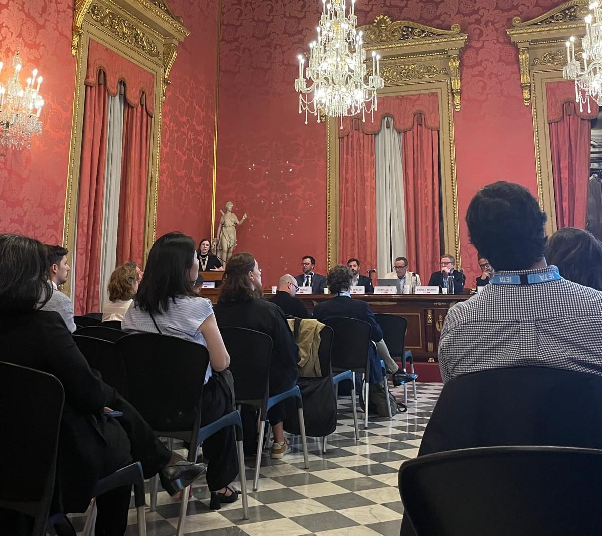 Session in progress inside the Llotja de Mar, Barcelona, with attendees seated beneath ornate chandeliers and red damask walls at IETA’s European Climate Summit 2026